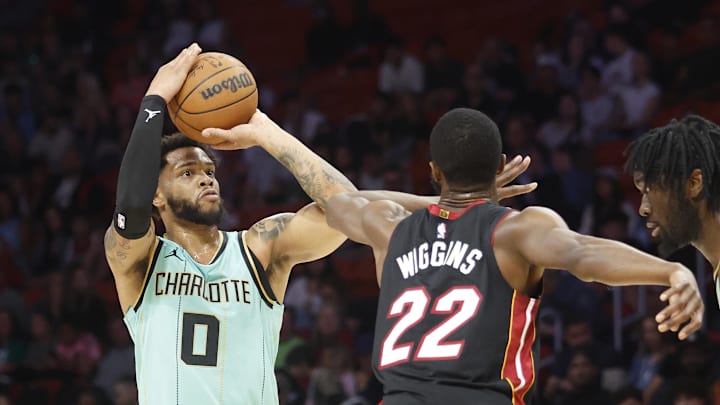 Mar 23, 2025; Miami, Florida, USA; Charlotte Hornets forward Miles Bridges (0) is defended by Miami Heat forward Andrew Wiggins (22) during the first half at Kaseya Center. Mandatory Credit: Rhona Wise-Imagn Images Mar 23, 2025; Miami, Florida, USA; Charlotte Hornets forward Miles Bridges (0) is defended by Miami Heat forward Andrew Wiggins (22) during the first half at Kaseya Center. Mandatory Credit: Rhona Wise-Imagn Images