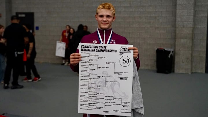 Bristol Central 150-pound wrestler Alex Lamarre is pictured with the 150-pound championship banner after winning the CIAC 150-pound State Open Title on Saturday, February 28, 2026 at the Floyd Little Athletic Center in New Haven, Connecticut. 