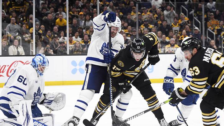 Apr 30, 2024; Boston, Massachusetts, USA; Toronto Maple Leafs defenseman Jake McCabe (22) ties up Boston Bruins center Charlie Coyle (13) in front of goaltender Joseph Woll (60) during the third period in game five of the first round of the 2024 Stanley Cup Playoffs at TD Garden. Mandatory Credit: Bob DeChiara-Imagn Images