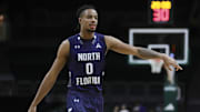 North Florida Ospreys guard Jasai Miles (0) signals against the Miami Hurricanes during the second half at Watsco Center.
