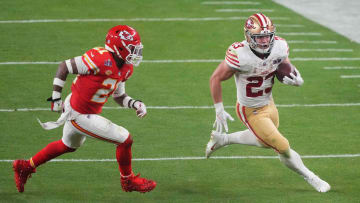 Feb 11, 2024; Paradise, Nevada, USA; San Francisco 49ers running back Christian McCaffrey (23) runs with the ball against Kansas City Chiefs safety Mike Edwards (21) during overtime of Super Bowl LVIII at Allegiant Stadium. Mandatory Credit: Joe Camporeale-USA TODAY Sports
