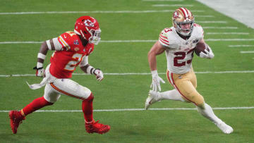 Feb 11, 2024; Paradise, Nevada, USA; San Francisco 49ers running back Christian McCaffrey (23) runs with the ball against Kansas City Chiefs safety Mike Edwards (21) during overtime of Super Bowl LVIII at Allegiant Stadium. Mandatory Credit: Joe Camporeale-USA TODAY Sports