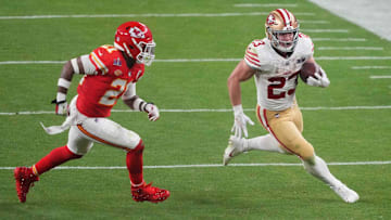 Feb 11, 2024; Paradise, Nevada, USA; San Francisco 49ers running back Christian McCaffrey (23) runs with the ball against Kansas City Chiefs safety Mike Edwards (21) during overtime of Super Bowl LVIII at Allegiant Stadium.