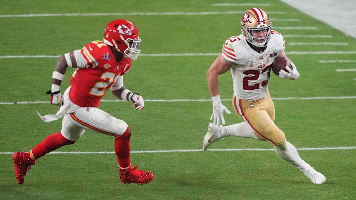 Feb 11, 2024; Paradise, Nevada, USA; San Francisco 49ers running back Christian McCaffrey (23) runs with the ball against Kansas City Chiefs safety Mike Edwards (21) during overtime of Super Bowl LVIII at Allegiant Stadium.