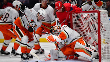 Nov 15, 2022; Anaheim, California, USA; Anaheim Ducks right wing Frank Vatrano (77) helps goaltender John Gibson (36) defend the goal against Detroit Red Wings center Oskar Sundqvist (70) during the first period at Honda Center. Mandatory Credit: Gary A. Vasquez-Imagn Images