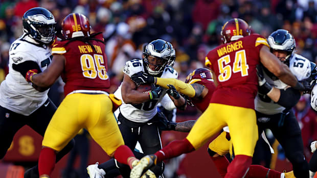 Dec 22, 2024; Landover, Maryland, USA; Eagles' Saquon Barkley runs the ball against the Commanders.