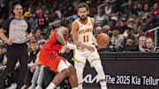 Jan 25, 2025; Atlanta, Georgia, USA; Atlanta Hawks guard Trae Young (11) dribbles against Toronto Raptors guard Jamal Shead (23) during the first half at State Farm Arena. Mandatory Credit: Dale Zanine-Imagn Images