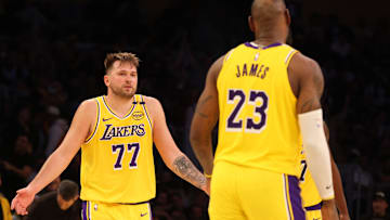 Feb 27, 2025; Los Angeles, California, USA; Los Angeles Lakers guard Luka Doncic (77) celebrates with forward LeBron James (23) after making a basket during the fourth quarter against the Minnesota Timberwolves at Crypto.com Arena. Mandatory Credit: Jason Parkhurst-Imagn Images