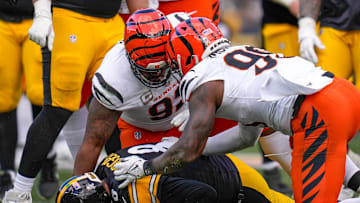 Cincinnati Bengals defensive tackle B.J. Hill (92) and defensive end Myles Murphy (99) sack Pittsburgh Steelers quarterback Aaron Rodgers (8) in the second quarter of the NFL Week 11 game between the Pittsburgh Steelers and the Cincinnati Bengals at Acrisure Stadium in Pittsburgh on Sunday, Nov. 16, 2025. The Steelers led 10-6 at halftime.