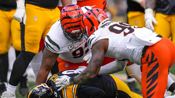 Cincinnati Bengals defensive tackle B.J. Hill (92) and defensive end Myles Murphy (99) sack Pittsburgh Steelers quarterback Aaron Rodgers (8) in the second quarter of the NFL Week 11 game between the Pittsburgh Steelers and the Cincinnati Bengals at Acrisure Stadium in Pittsburgh on Sunday, Nov. 16, 2025. The Steelers led 10-6 at halftime.