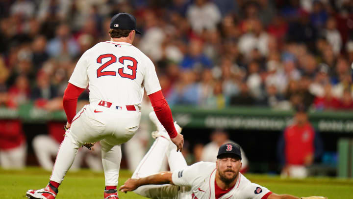 Weissert (57) catches the bunt in the ninth inning at Fenway Park.