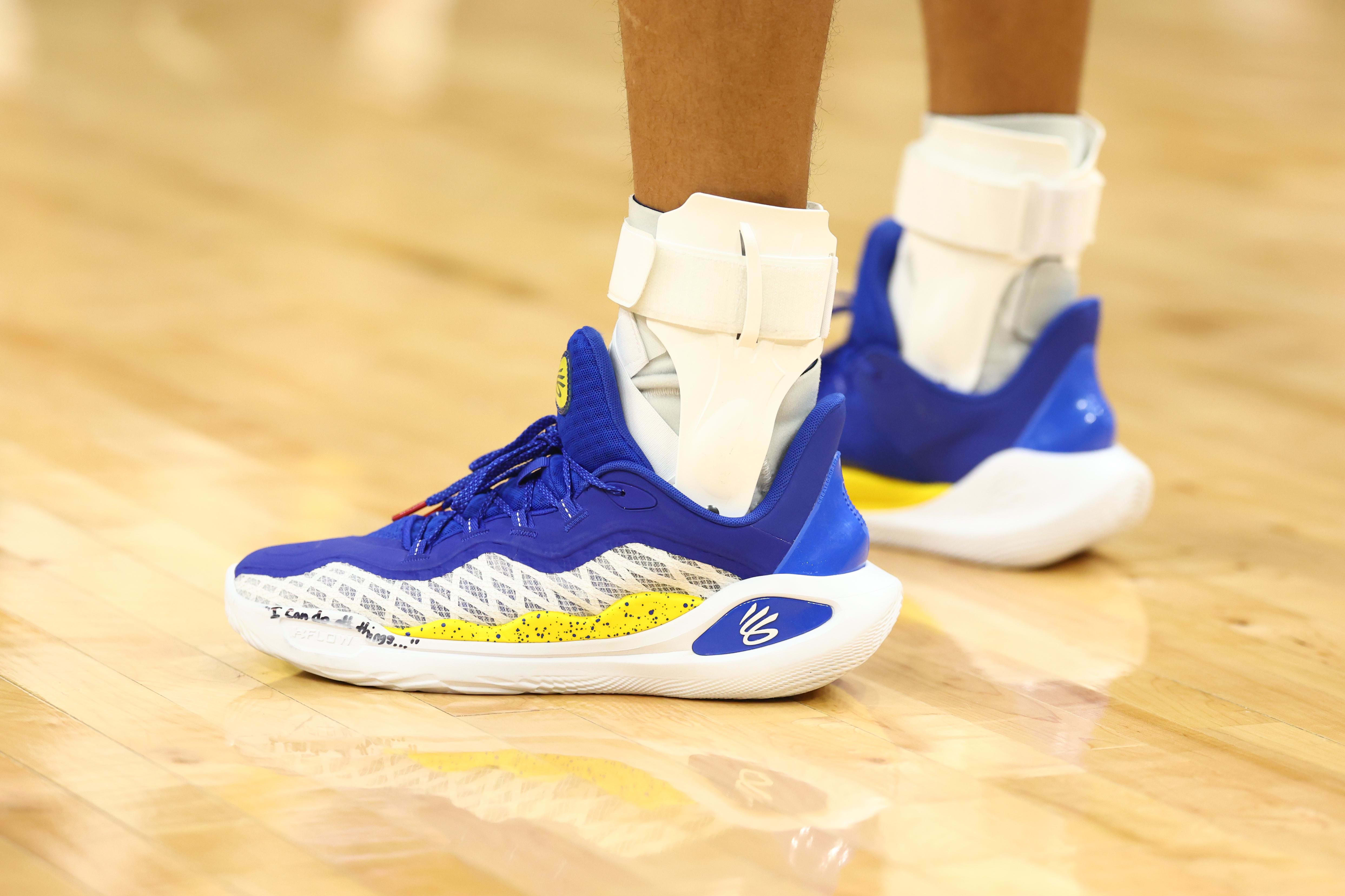 Golden State Warriors guard Stephen Curry's blue and white Under Armour shoes.