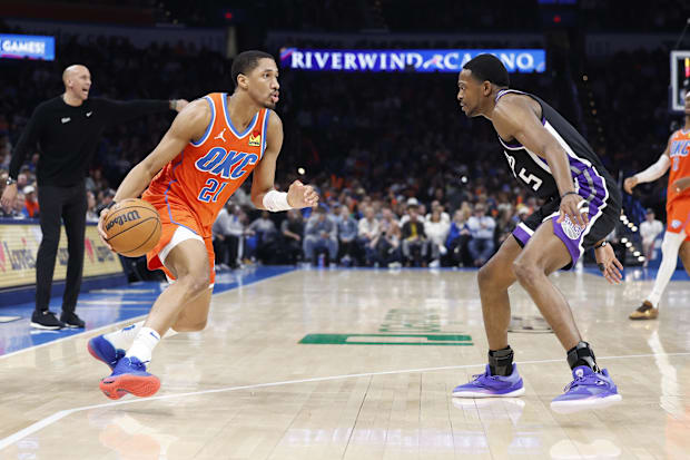 Oklahoma City Thunder guard Aaron Wiggins (21) drives to the basket against Sacramento Kings guard De'Aaron Fox (5) during th