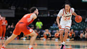 Dec 7, 2024; Coral Gables, Florida, USA; Miami Hurricanes guard Nijel Pack (24) dribbles the basketball as Clemson Tigers guard Jaeden Zackery (11) defends during the second half at Watsco Center. Mandatory Credit: Sam Navarro-Imagn Images