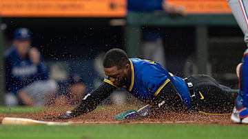 Sep 13, 2024; Seattle, Washington, USA;  Seattle Mariners right fielder Victor Robles (10) slides safely into home plate to score a run during the seventh inning against the Texas Rangers at T-Mobile Park. Mandatory Credit: Stephen Brashear-Imagn Images