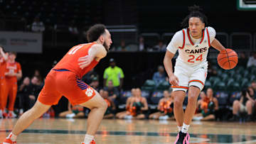 Dec 7, 2024; Coral Gables, Florida, USA; Miami Hurricanes guard Nijel Pack (24) dribbles the basketball as Clemson Tigers guard Jaeden Zackery (11) defends during the second half at Watsco Center. Mandatory Credit: Sam Navarro-Imagn Images