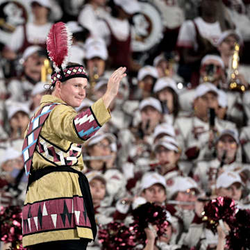 Sep 3, 2023; Orlando, Florida, USA; Florida State Seminoles head drum major John Justice directs the Marching Chiefs during the game against the Louisiana State Tigers at Camping World Stadium. Mandatory Credit: Melina Myers-Imagn Images