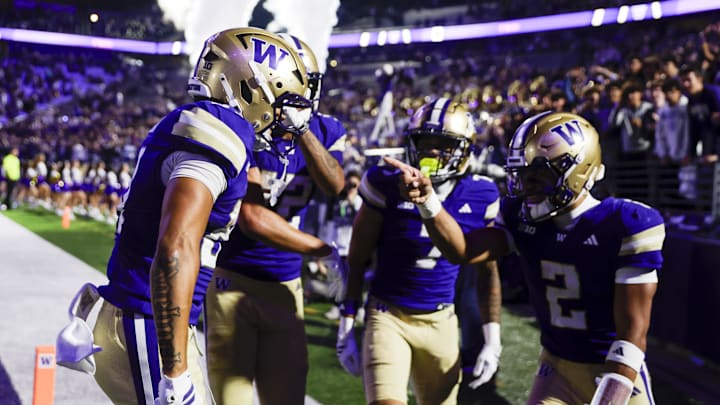 Sep 6, 2025; Seattle, Washington, USA; Washington Huskies wide receiver Dezmen Roebuck (81, left) celebrates with quarterback Demond Williams Jr. (2) after catching a touchdown pass against the UC Davis Aggies during the third quarter at Husky Stadium. Mandatory Credit: Joe Nicholson-Imagn Images