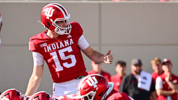 Nov 15, 2025; Bloomington, Indiana, USA; Indiana Hoosiers quarterback Fernando Mendoza (15) motions to his team during the second half against the Wisconsin Badgers at Memorial Stadium. Mandatory Credit: Marc Lebryk-Imagn Images