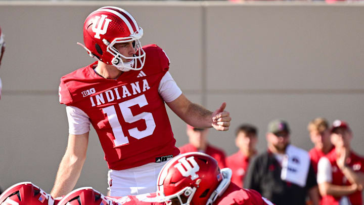 Nov 15, 2025; Bloomington, Indiana, USA; Indiana Hoosiers quarterback Fernando Mendoza (15) motions to his team during the second half against the Wisconsin Badgers at Memorial Stadium. Mandatory Credit: Marc Lebryk-Imagn Images