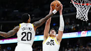 Oct 30, 2023; Denver, Colorado, USA; Utah Jazz center Walker Kessler (24) and forward John Collins (20) reach for a rebound in the fourth quarter against the Denver Nuggets  at Ball Arena. Mandatory Credit: Ron Chenoy-Imagn Images