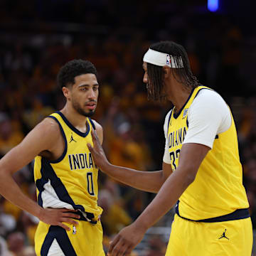 May 25, 2025; Indianapolis, Indiana, USA; Indiana Pacers guard Tyrese Haliburton (0) and center Myles Turner (33) talk during the third quarter of game three of the eastern conference finals for the 2025 NBA Playoffs at Gainbridge Fieldhouse. Mandatory Credit: Trevor Ruszkowski-Imagn Images