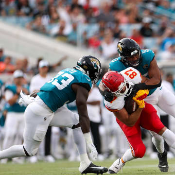 Aug 10, 2024; Jacksonville, Florida, USA; Kansas City Chiefs tight end Travis Kelce (87) is tackled by Jacksonville Jaguars defensive end Trevis Gipson (50) in the first quarter during preseason at EverBank Stadium. Mandatory Credit: Nathan Ray Seebeck-USA TODAY Sports