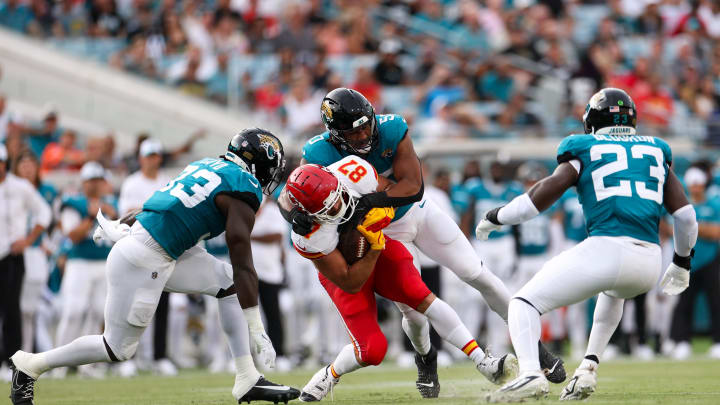 Aug 10, 2024; Jacksonville, Florida, USA; Kansas City Chiefs tight end Travis Kelce (87) is tackled by Jacksonville Jaguars defensive end Trevis Gipson (50) in the first quarter during preseason at EverBank Stadium. Mandatory Credit: Nathan Ray Seebeck-USA TODAY Sports