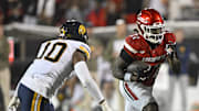 Nov 8, 2025; Louisville, Kentucky, USA;  Louisville Cardinals running back Keyjuan Brown (22) runs the ball against California Golden Bears linebacker Jayden Wayne (10) in overtime at L&N Federal Credit Union Stadium. California defeated Louisville 29-26. Mandatory Credit: Jamie Rhodes-Imagn Images