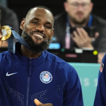 Aug 10, 2024; Paris, France; United States guard LeBron James (6) celebrates with the gold medal after defeating France in the men's basketball gold medal game during the Paris 2024 Olympic Summer Games at Accor Arena. Mandatory Credit: Rob Schumacher-USA TODAY Sports