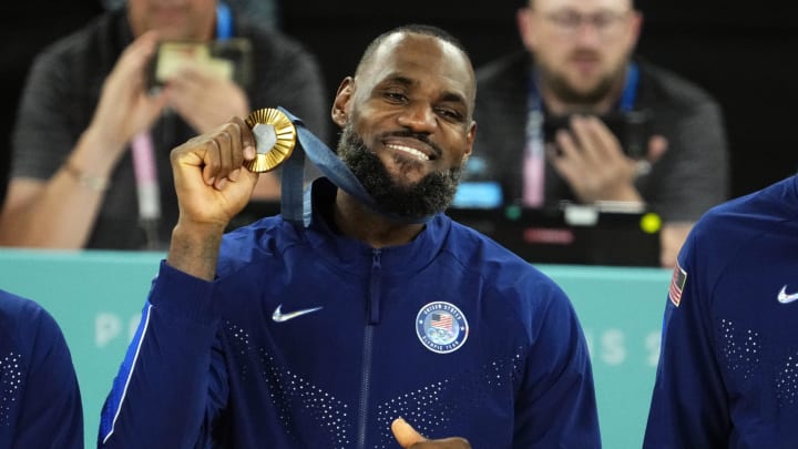 Aug 10, 2024; Paris, France; United States guard LeBron James (6) celebrates with the gold medal after defeating France in the men's basketball gold medal game during the Paris 2024 Olympic Summer Games at Accor Arena. Mandatory Credit: Rob Schumacher-USA TODAY Sports