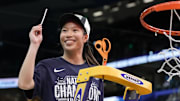 Apr 6, 2025; Tampa, FL, USA; Connecticut Huskies guard Kaitlyn Chen (20) holds up a piece of the net after the national championship of the women's 2025 NCAA tournament against the South Carolina Gamecocks at Amalie Arena.