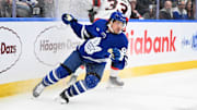 Mar 15, 2025; Toronto, Ontario, CAN;  Toronto Maple Leafs forward Nick Robertson (89) pivots away from a bodycheck from Ottawa Senators defenseman Nikolas Matinpalo (33) in the third period at Scotiabank Arena. Mandatory Credit: Dan Hamilton-Imagn Images