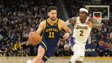 Jan 27, 2024; San Francisco, California, USA; Golden State Warriors guard Klay Thompson (11) dribbles against Los Angeles Lakers forward Jarred Vanderbilt (2) during the fourth quarter at Chase Center. Mandatory Credit: Darren Yamashita-USA TODAY Sports