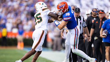 Aug 31, 2024; Gainesville, Florida, USA; Florida Gators quarterback Graham Mertz (15) runs into Miami Hurricanes defensive back Jadais Richard (25) during the first half at Ben Hill Griffin Stadium. Mandatory Credit: Matt Pendleton-Imagn Images