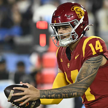 Nov 23, 2024; Pasadena, California, USA; USC Trojans quarterback Jayden Maiava (14) takes the snap during the first quarter against the UCLA Bruins at Rose Bowl. Mandatory Credit: Robert Hanashiro-Imagn Images