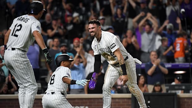Colorado Rockies players in white jerseys