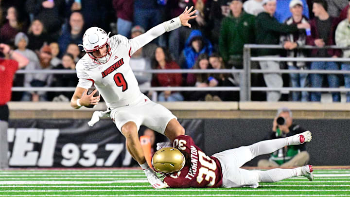Oct 25, 2024; Chestnut Hill, Massachusetts, USA; Louisville Cardinals quarterback Tyler Shough (9) is tackled by Boston College Eagles defensive back Omar Thornton (30) during the first half at Alumni Stadium. Mandatory Credit: Eric Canha-Imagn Images
