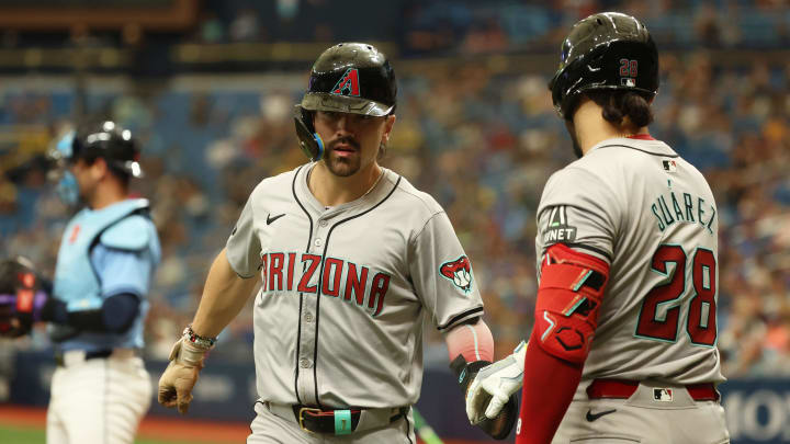 Aug 18, 2024; St. Petersburg, Florida, USA; Arizona Diamondbacks outfielder Corbin Carroll (7) is congratulated by ]Arizona Diamondbacks third base Eugenio Suarez (28) after he scores a run against the Tampa Bay Rays during the tenth inning at Tropicana Field. Mandatory Credit: Kim Klement Neitzel-USA TODAY Sports