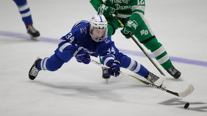 Brookfield Co-op's Cooper Simon (34) makes a diving pass during their WIAA Division 1 boys championship hockey game Saturday, March 2, 2024, at Bob Suter's Capitol Ice Arena in Middleton, Wisconsin.