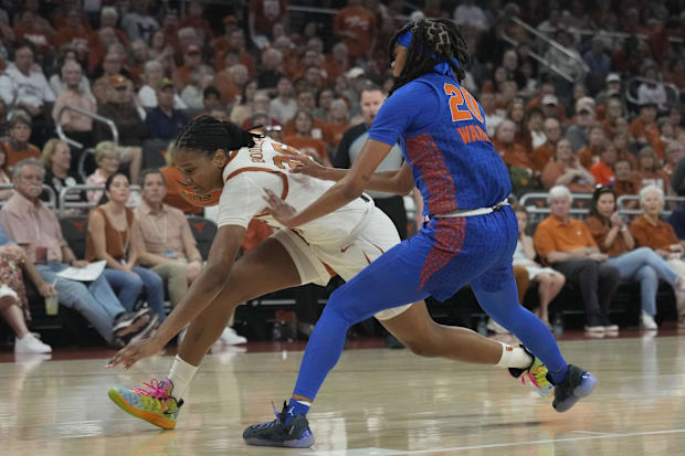 Madison Booker drives to the basket against Florida