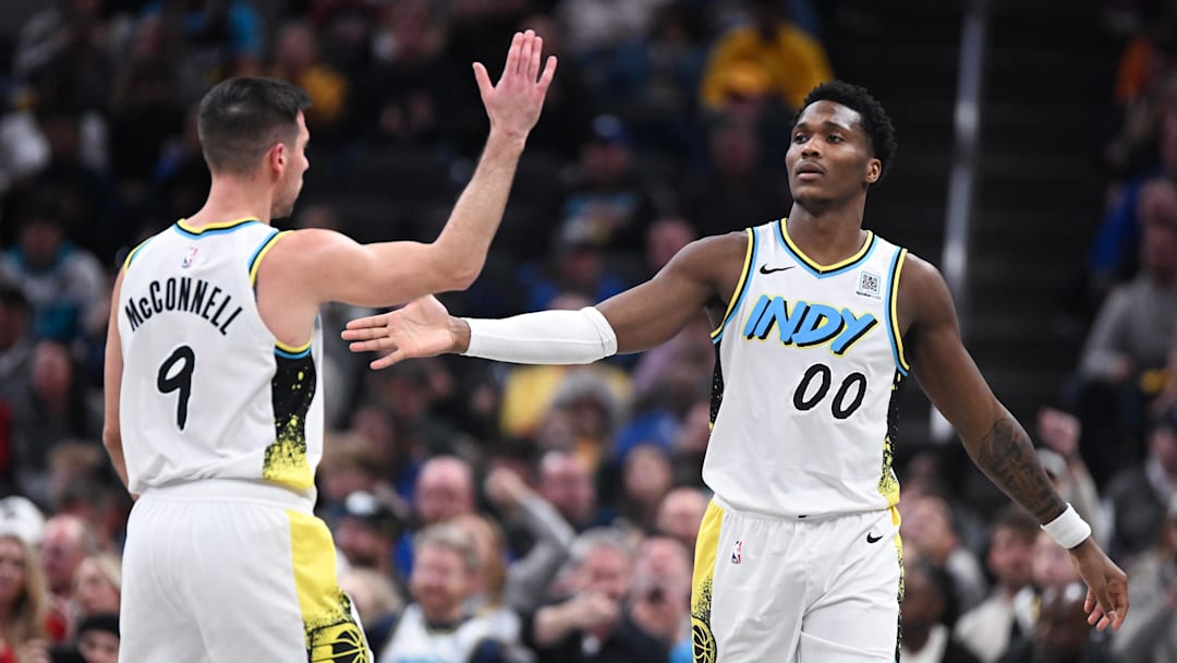 Dec 8, 2024; Indianapolis, Indiana, USA; Indiana Pacers guard T.J. McConnell (9) high-fives Indiana Pacers guard Bennedict Mathurin (00) after a play during the second half against the Charlotte Hornets at Gainbridge Fieldhouse. Mandatory Credit: Robert Goddin-Imagn Images 