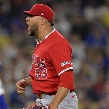 Jun 21, 2024; Los Angeles, California, USA;  Los Angeles Angels relief pitcher Carlos Estevez (53) reacts after striking out Los Angeles Dodgers second baseman Gavin Lux (9) in the 10th inning earning a save in the game at Dodger Stadium. 