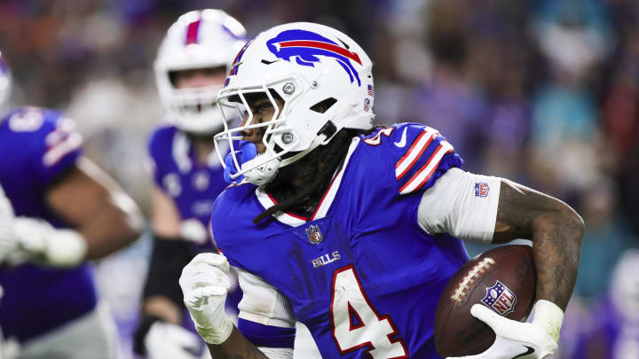 Jan 7, 2024; Miami Gardens, Florida, USA; Buffalo Bills running back James Cook (4) runs with the football against the Miami Dolphins during the fourth quarter at Hard Rock Stadium. Mandatory Credit: Sam Navarro-USA TODAY Sports