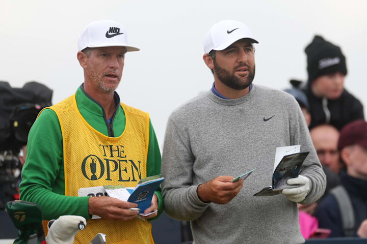 Scottie Scheffler talks to his caddie Ted Scott on the 15th hole during the first round of The 153rd Open Championship.