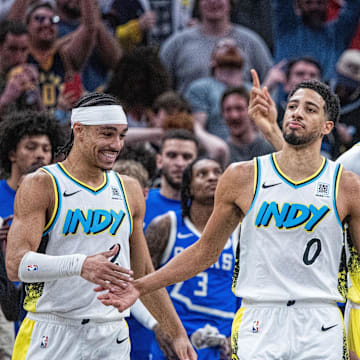 Mar 11, 2025; Indianapolis, Indiana, USA; Indiana Pacers teammates swarm and celebrate the game tying basket made by guard Tyrese Haliburton (0) in the second half  against the Milwaukee Bucks at Gainbridge Fieldhouse. Mandatory Credit: Trevor Ruszkowski-Imagn Images