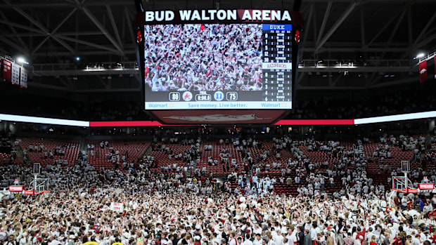 Arkansas fans rush the court following the Razorbacks' 80-75 win against the Duke Blue Devils at Bud Walton Arena on Nov. 29,