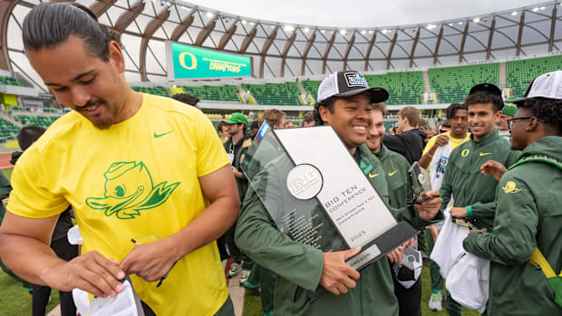 Oregon’s Pat Vialva, carries the Big Ten Trophy during day three of the Big Ten Outdoor Track and Field Championships on May 