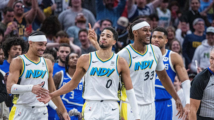 Mar 11, 2025; Indianapolis, Indiana, USA; Indiana Pacers teammates swarm and celebrate the game tying basket made by guard Tyrese Haliburton (0) in the second half  against the Milwaukee Bucks at Gainbridge Fieldhouse. Mandatory Credit: Trevor Ruszkowski-Imagn Images