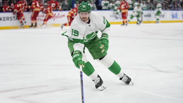 Mar 17, 2025; Toronto, Ontario, CAN; Toronto Maple Leafs defenceman Oliver Ekman-Larsson (95) gets control of the puck against the Calgary Flames during the second period at Scotiabank Arena. Mandatory Credit: John E. Sokolowski-Imagn Images